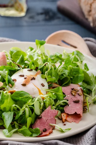 Lamb's lettuce salad with poached egg and nuts — Stock Photo, Image