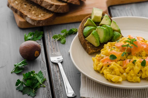 Salmon scrambled eggs and avocado toast — Stock Photo, Image