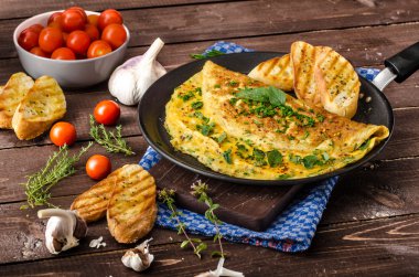 Herb omelette with chives and oregano sprinkled with Herb omelette with chili flakes