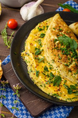 Herb omelette with chives and oregano sprinkled with Herb omelette with chili flakes