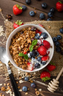 Pişmiş granola ve meyveleri küçük kase yoğurt