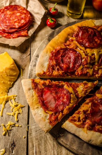 Pizza z salami rustykalny z serem cheddar i chorizo — Zdjęcie stockowe