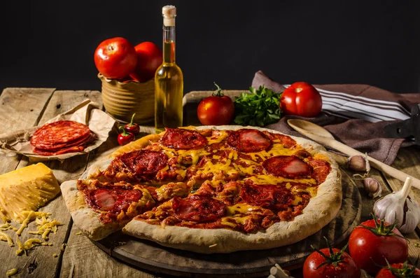 Rustic salami pizza with cheddar cheese and chorizo — Stock Photo, Image