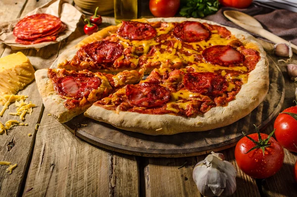 Rustic salami pizza with cheddar cheese and chorizo — Stock Photo, Image