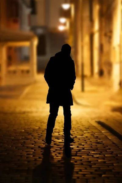 mysterious figure of a man on a deserted street of the old city