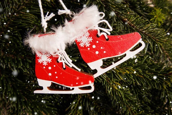 Christmas and New Years toys hang on the tree. red ice skates made — Stock Photo, Image