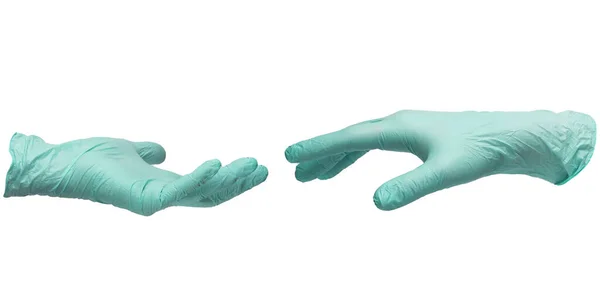 Due mani in guanti sterili di nitrile color menta si allungano. Foto Stock
