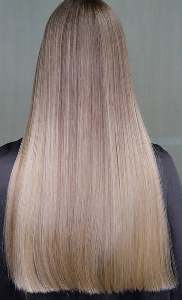 Stunningly beautiful hair models painted in a light color look from the back