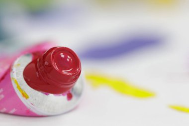 large image of an open tube of red watercolor paint 