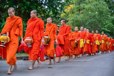 Buddhist monks daily ritual of collecting alms and offerings clipart