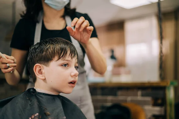 Corte de pelo para niño pequeño, peluquero profesional haciendo corte de pelo. Peinado para niños —  Fotos de Stock