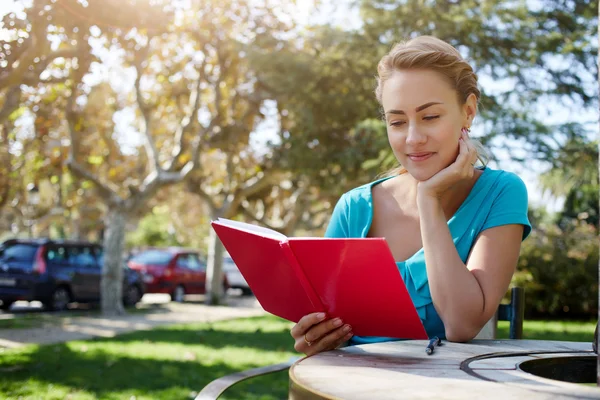 Woman is reading interesting book — Stock Photo, Image