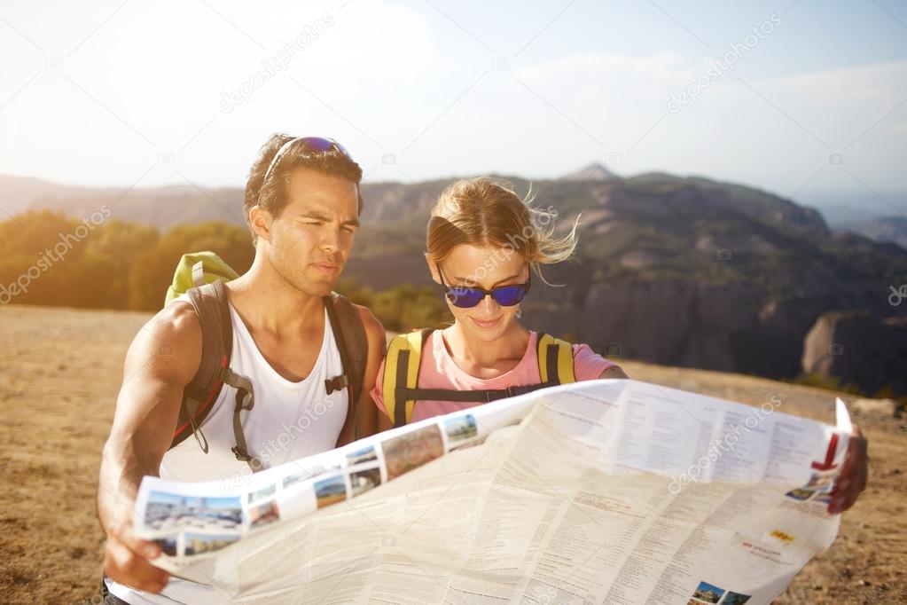Male and female hikers are walking together in mountains during long awaiting summer weekend