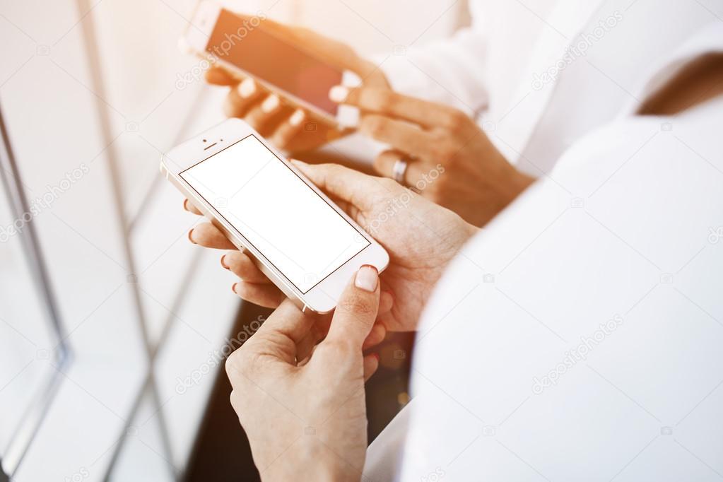 Hands holding mobile phones