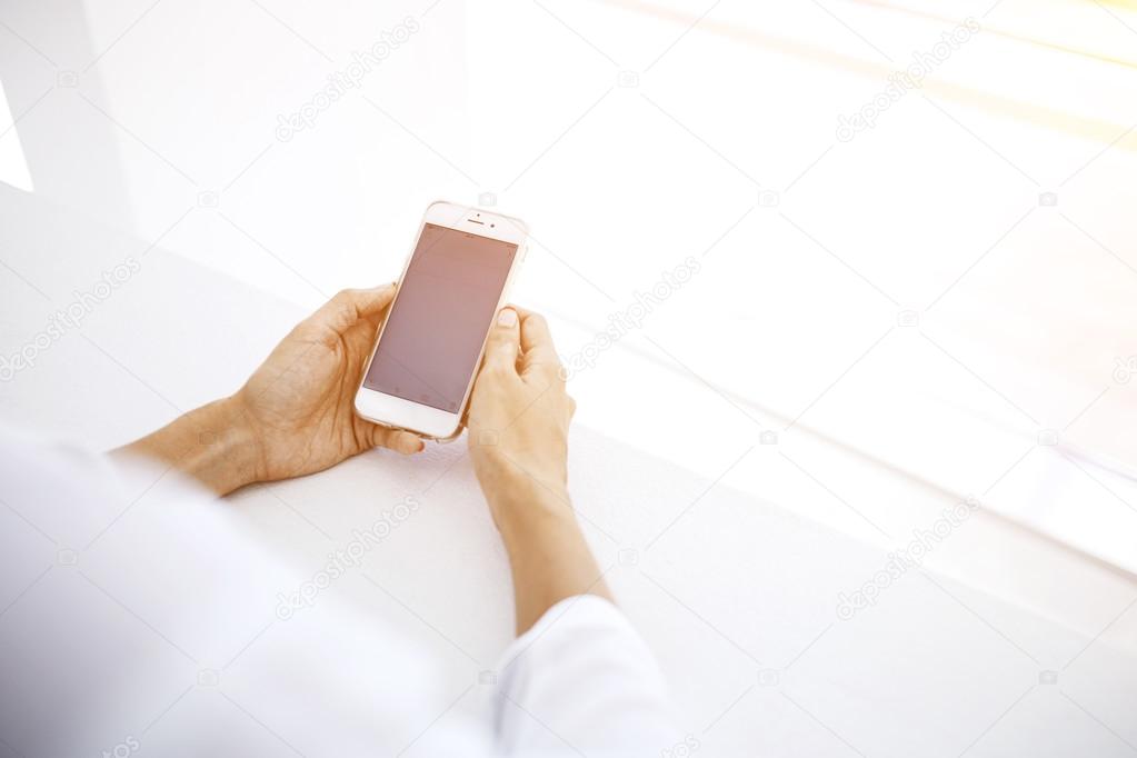Woman`s hands holding smart phone