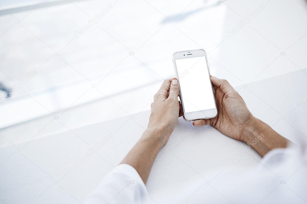 Woman`s hands is holding smart phone