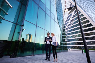 Young successful businessman with female secretary