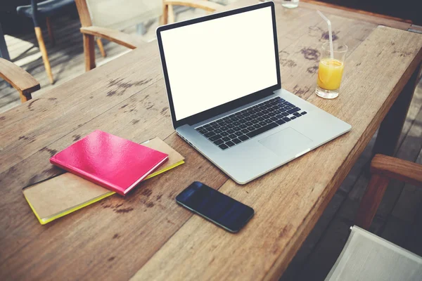 Laptop near mobile phone on wooden table — Stock Photo, Image