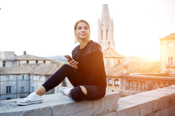  Young attractive student is using cell telephone during rest between lectures in University