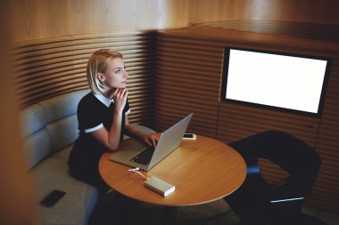 Female CEO at table with open laptop 