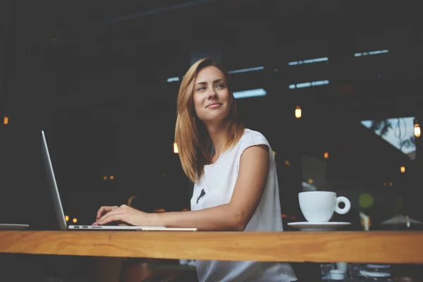 Beautiful woman successful freelancer using laptop computer while sitting in coffee shop