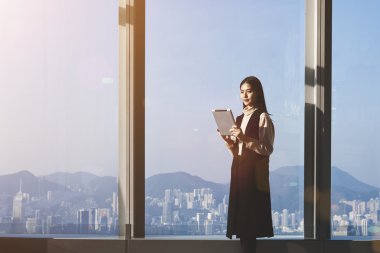 Young woman holding touch pad
