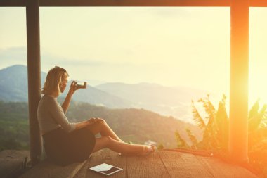 Woman taking photo with cell telephone