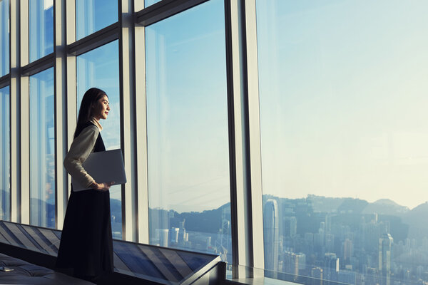 Female executive holding laptop computer