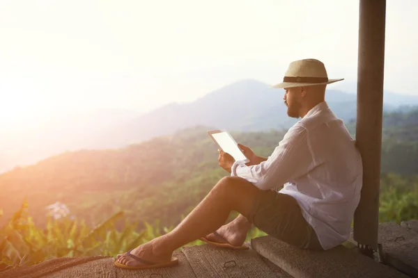 Man traveler holding digital tablet