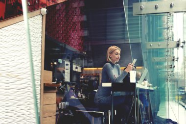 Woman watching video on cell telephone