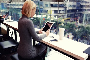 Businesswoman reading news on touch pad 