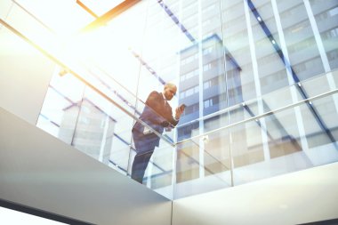 Businessman reading news via cell telephone