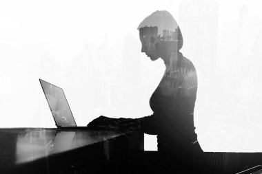 Young businesswoman is keyboarding on net-book at office desktop
