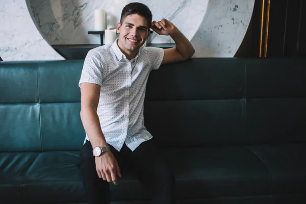 Young Male White Shirt Sitting Comfortable Leather Couch Marble Decor — Stock Photo, Image