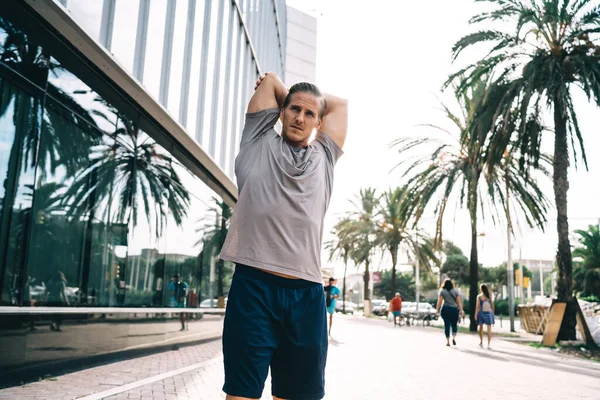 Determined Male Athlete Stretching Body Morning Training Urbn City Caucasian — Stock Photo, Image