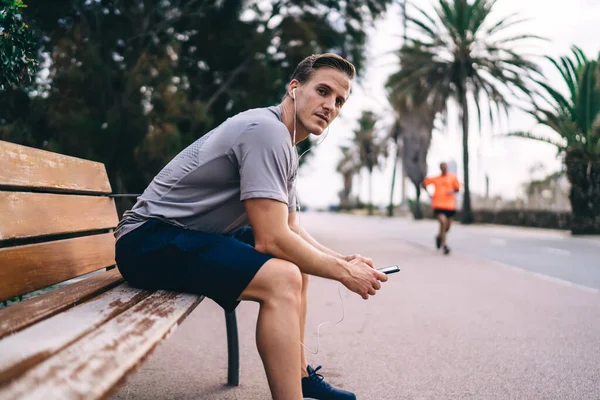 Portrait Caucasian Male Trainer Sitting Urban Bench Looking Camera Whle — Stock Photo, Image