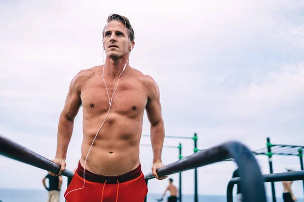 Serious Caucasian Guy Training Strength Power Muscles Workout Topless Earphones — Stock Photo, Image
