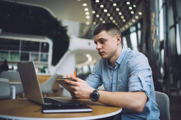 Baixo Freelancer Masculino Focado Desgaste Casual Sentado Com Prancheta Mão — Fotografia de Stock