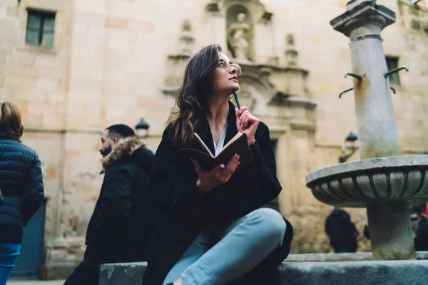 Pensive Female Trendy Outfit Eyeglasses Sitting Stone Border Fountain Creating — Stock Photo, Image