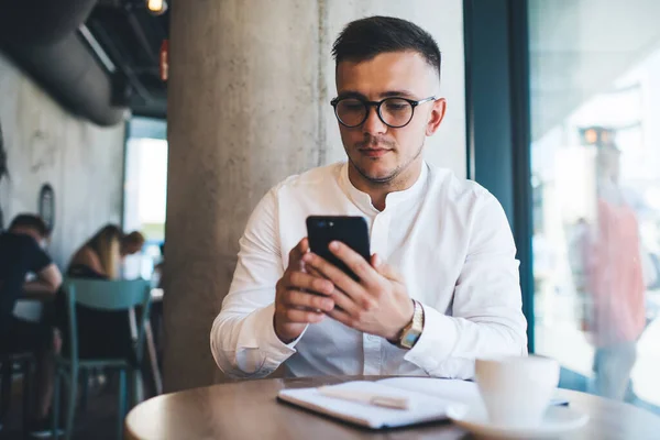Hezký Mladý Muž Formálním Oblečení Brýle Pomocí Smartphonu Dělat Poznámky — Stock fotografie