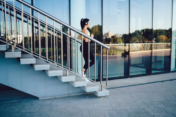 Side View Slim Female Athlete Sportswear Sneakers Headphones Running Downstairs — Stock Photo, Image
