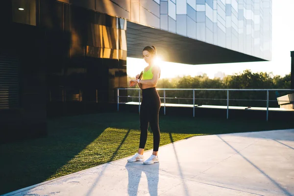 Fit Female Athlete Activewear Standing City Street Glass Building Listening — Stock Photo, Image