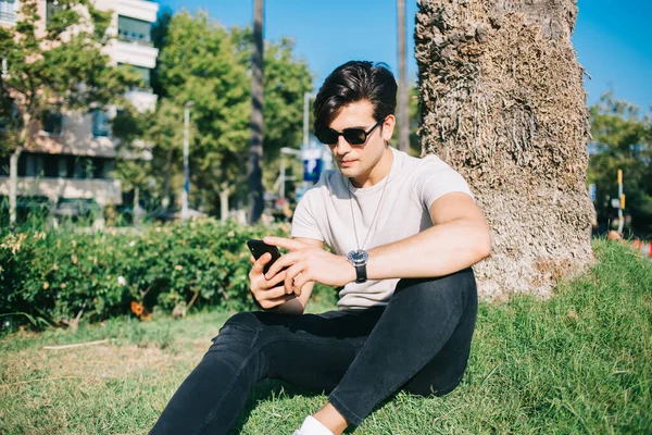 Serious Pensive Caucasian Hipster Guy Sunglasses Reading News Smartphone Sitting — Stock Photo, Image