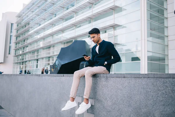 Handsome Millennial Hipster Guy Trendy Apparel Sitting Urban Setting Background — Stock Photo, Image