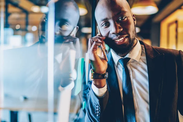 Portrait of dark skinned executive manager connecting to office wireless for making contact calling, African American professional lawyer communicating with customer discussing corporate meeting