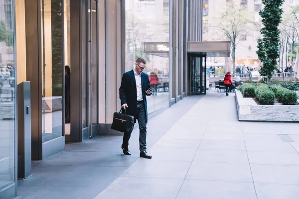 Young Entrepreneur Dressed Business Suit Glasses Using Smartphone Holding Briefcase — Stock Photo, Image