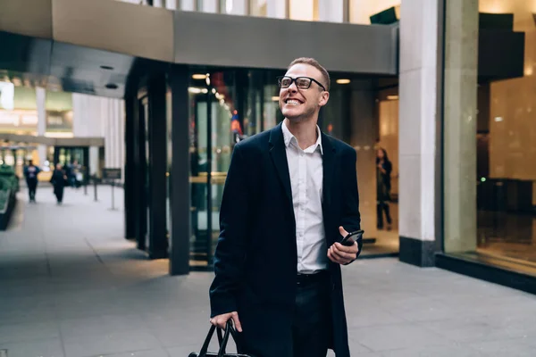 Cheerful Businessman White Shirt Black Coat Eyeglasses Holding Smartphone Laughing — Stock Photo, Image