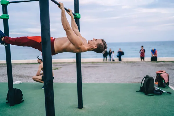 强壮的高加索男子运动员赤身裸体在海滨的水平线上训练休闲感 力量和活力 运动员锻炼时保持完美的体形和肌肉力量 — 图库照片