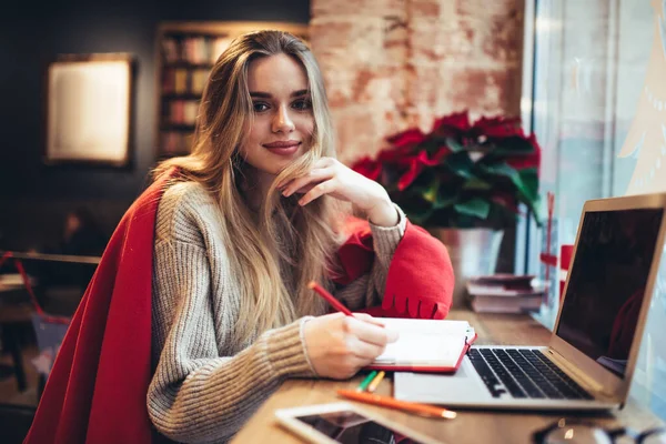 Calm Young Woman Sweater Plaid Draped Shoulders Writing Notebook While — Stock Photo, Image