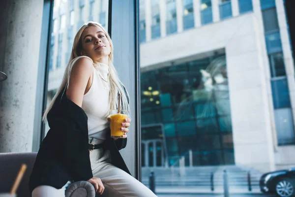 Young Woman Drinking Orange Juice While Sitting Flirting Pose Side — Stock Photo, Image